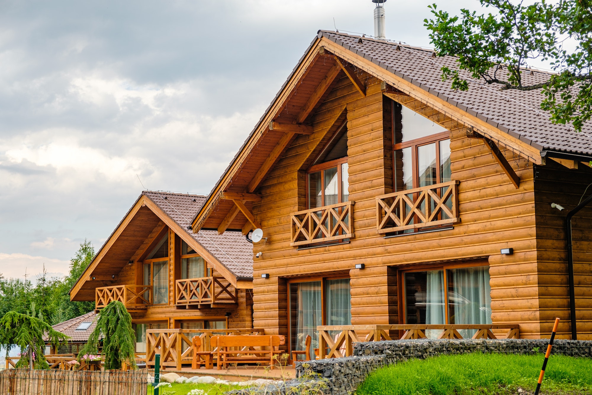 modern wooden house with big windows in the suburb building of houses for the key cottage or